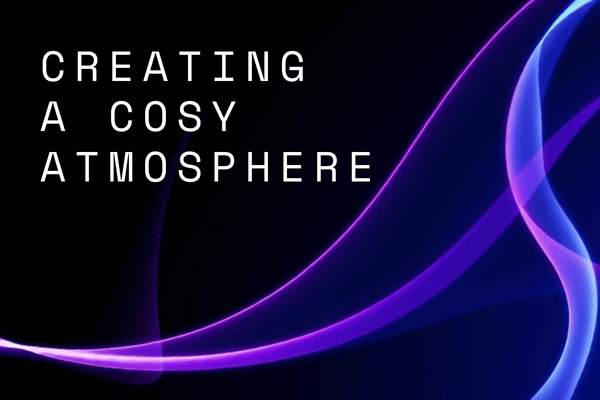 Title image with the text "creating a cosy atmosphere" with pink, purple and blue gradient lines on a black background. 