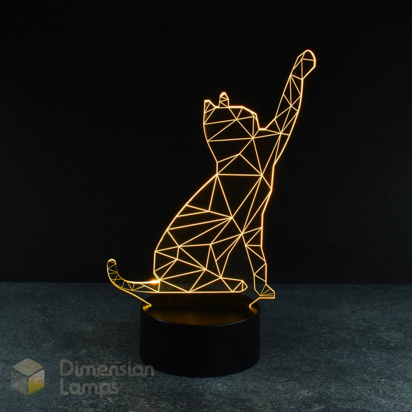 A yellow illuminated 3D lamp shows a geometric wireframe outline of a cat in a pawing motion, standing on a black base against a dark background. A playful gift idea for cat lovers across Australia.