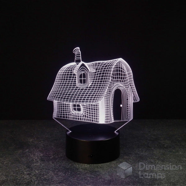 Nightlight: A 3D wireframe fairytale house lamp, glowing white, featuring a chimney, curved roof, and arched door. It rests on a black base against a dark background. A magical house and unique fantasy gift.