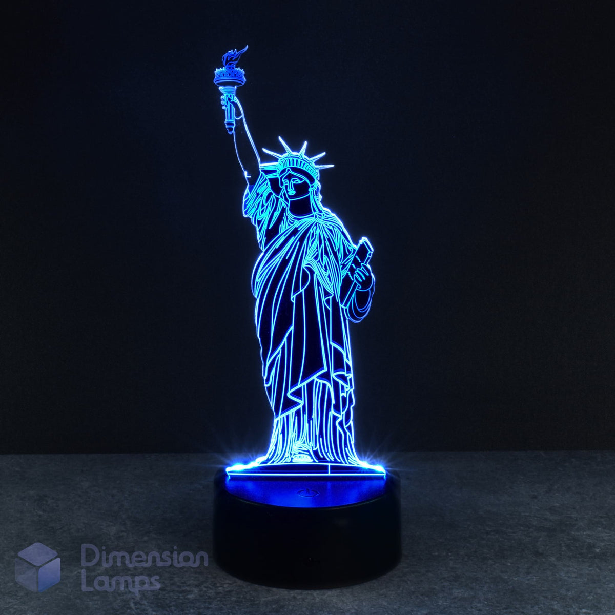 A 3D lamp on a black base illuminates the Statue of Liberty in blue against a dark backdrop. This iconic New York landmark offers a cool glow for homes across Australia.