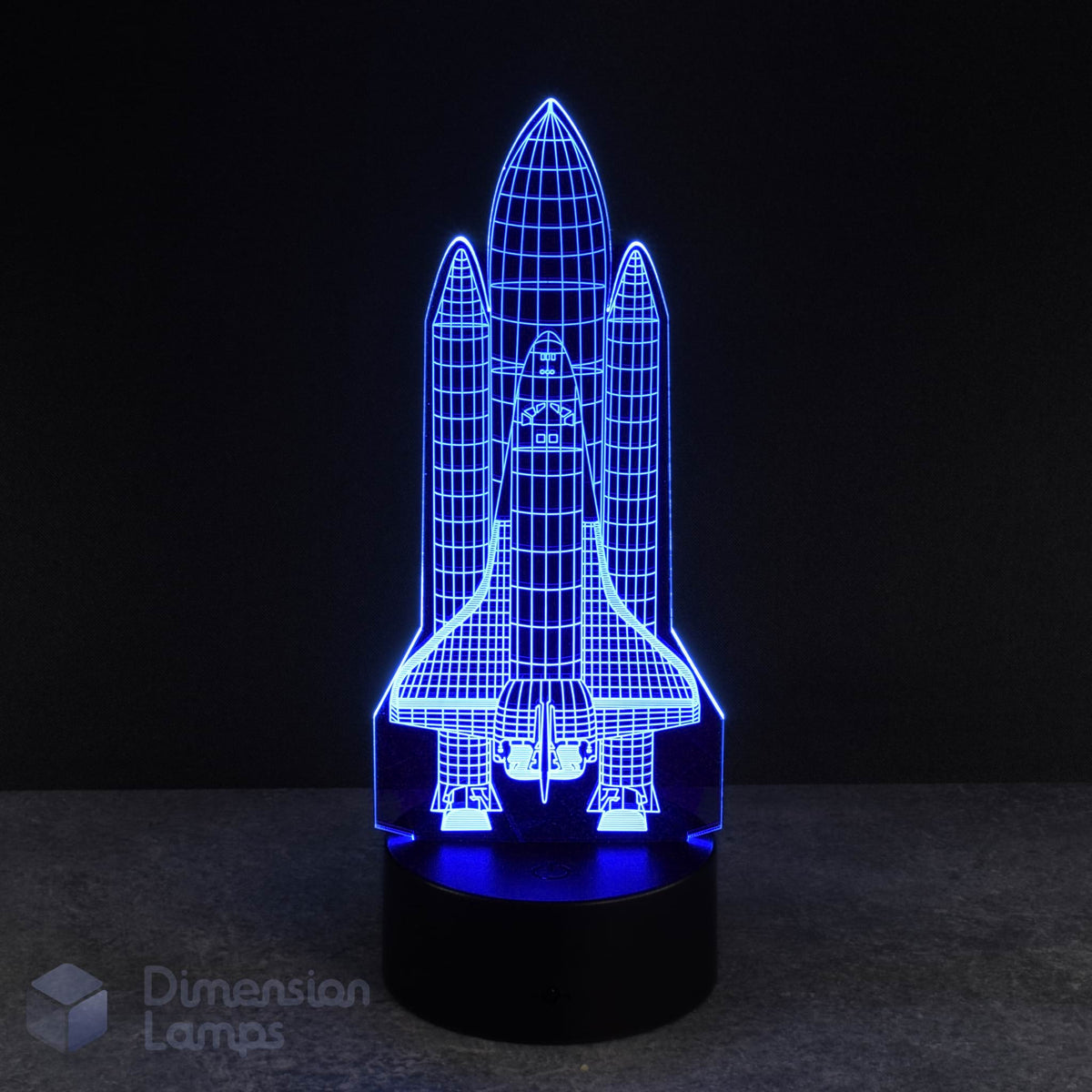 A blue LED light forms the shape of a space shuttle in this 3D lamp, set against a dark backdrop. This rocket-themed nightlight offers a unique and eye-catching option for a boys room decor.
