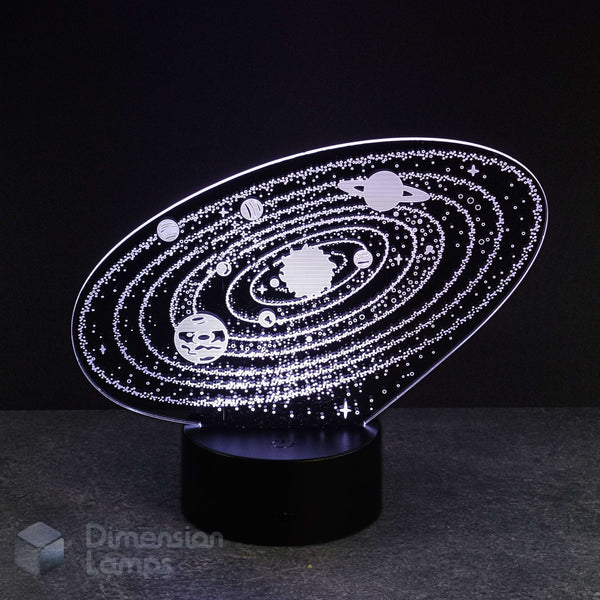 A white 3D LED lamp shows an etched depiction of the solar system, complete with planets orbiting the central sun, all illuminated on a black base against a dark background. This unique night light is ideal for a boys room in Australia.