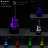 Bass guitar lamp displaying various colour modes on a dark background. Bass guitar collector gift idea. 