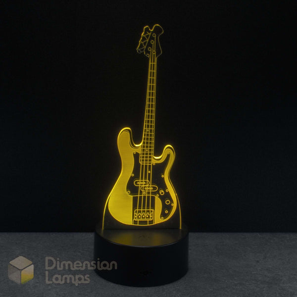 Bass guitar lamp with a black base on a dark background, featuring the brand 'Dimension Lamps'.