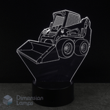 3D LED lamp shaped like a skid steer loader on a black background with 'Dimension Lamps' branding.