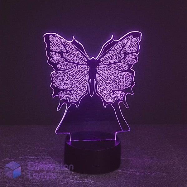 The Butterfly LED 3D illusion lamp, featuring a detailed butterfly wing design illuminated in a vibrant purple. Ideal girls night light.