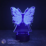 A butterfly-shaped LED night light glowing with a blue-purple light on a dark base, set against a dark background. A 'Dimension Lamps' logo watermark is visible in the bottom-left corner.
