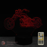 Motorcycle-shaped night light with remote control on a dark background