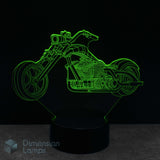 Motorcycle cruiser shaped night light with green outline on a black background