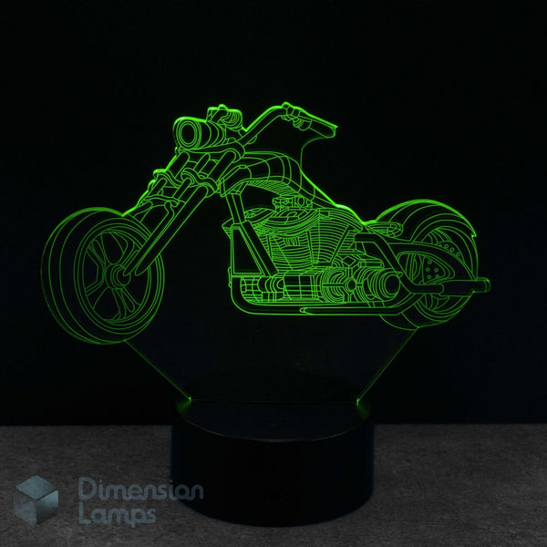 Motorcycle cruiser shaped night light with green outline on a black background