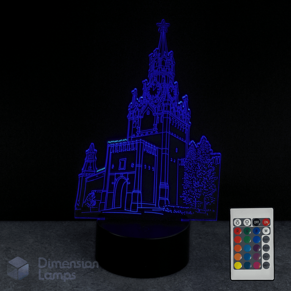 3D castle-shaped night light with a remote control on a dark background