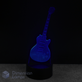 Guitar-shaped lamp emitting a blue light, gift idea for guitar collectors.