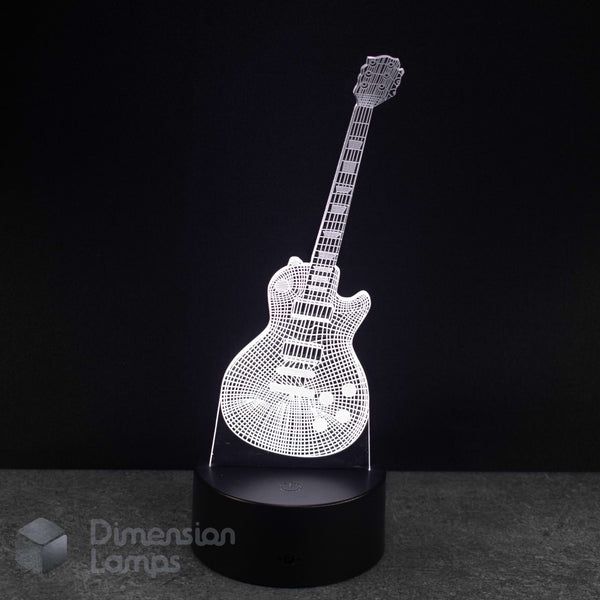 A 3D optical illusion LED night light shaped like an electric guitar, glowing with a white wireframe pattern on a black cylindrical base against a dark background. Music teacher gift idea. 