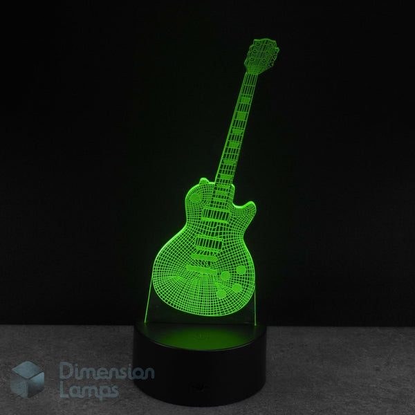 A 3D optical illusion LED night light shaped like an electric guitar, glowing bright green against a dark background on a black cylindrical base. The brand name 'Dimension Lamps' is visible as a watermark. Novelty guitar gift idea. 