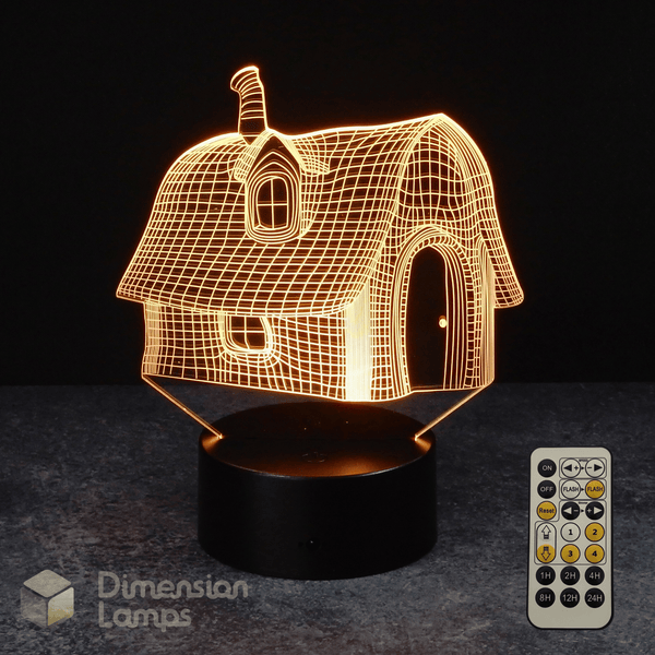 3D house-shaped night light with remote control on a dark surface, featuring Dimension Lamps brand.