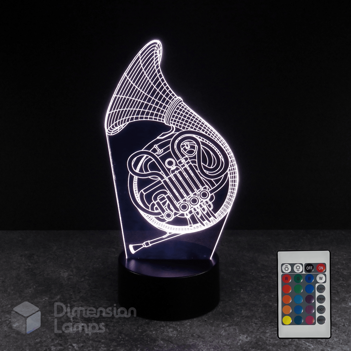 3D LED lamp shaped like a French horn with a remote control on a dark background