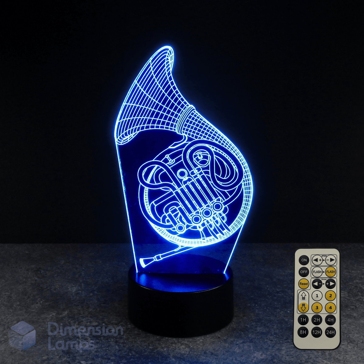 3D LED lamp shaped like a French horn with a remote control on a dark background