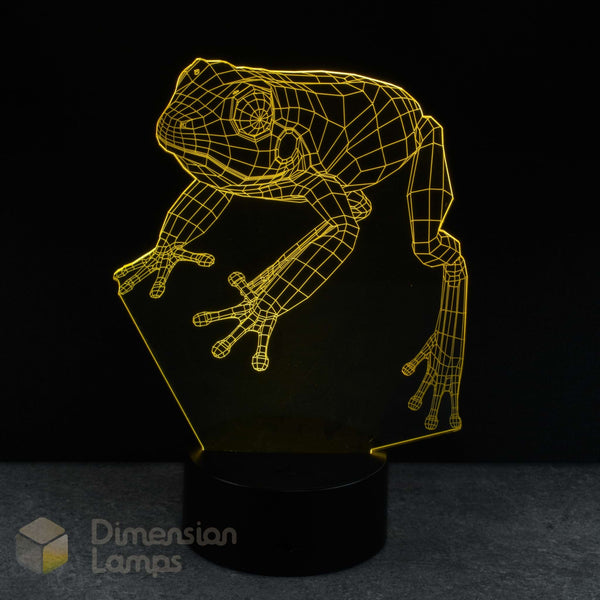 Frog-shaped yellow night light with a black background, frog lovers gift.