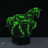 A modern geometric unicorn LED night light glowing green, shown on a black base against a dark background. Ideal gift for girls who love unicorns.
