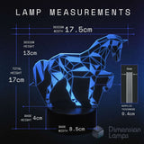 A blue geometric unicorn lamp on a black base with overlaid dimension labels. Includes dimensions for design width, height, and base dimensions.