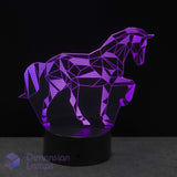 A geometric unicorn LED night light on a black base, glowing purple against a dark background. Girls unicorn gift idea. For girls into unicorns.