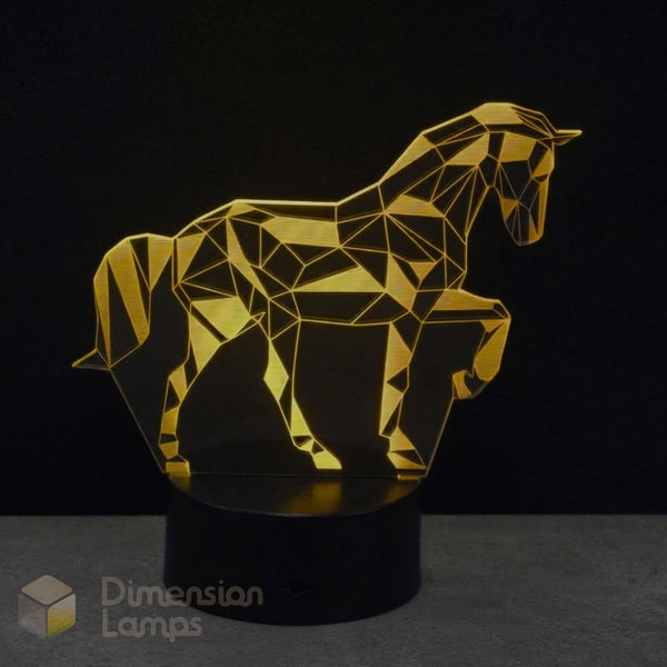 A girls geometric unicorn LED night light in gold yellow acrylic on a black base, against a dark background. The name 'Dimension Lamps' in the corner.
