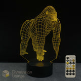 A gorilla 3D lamp with yellow wireframe outline on a black base, shown with a 7 colour remote control, a black background and a Dimension Lamps logo.
