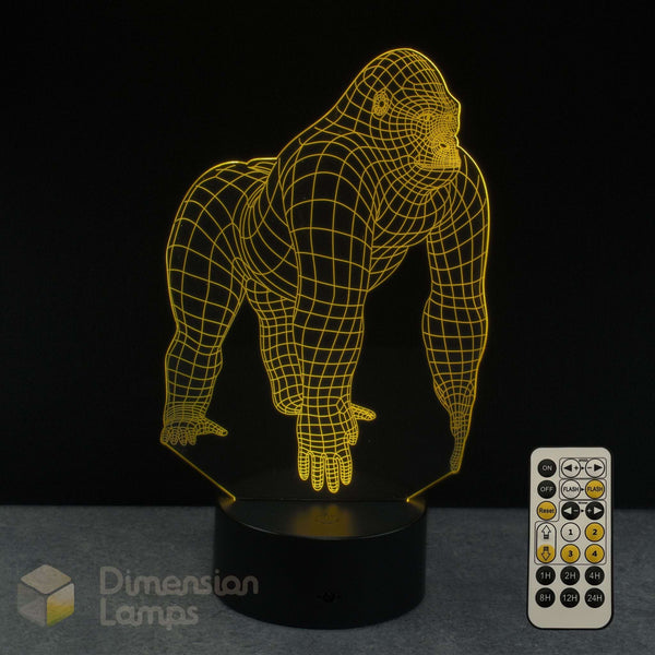 A gorilla 3D lamp with yellow wireframe outline on a black base, shown with a 7 colour remote control, a black background and a Dimension Lamps logo.