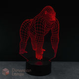 A 3D optical illusion night light shaped like a gorilla, glowing with red LED lines on a black circular base against a dark background.
