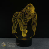 A 3D optical illusion LED lamp shaped like a gorilla, glowing with a yellow wireframe outline on a black base, set against a dark background.