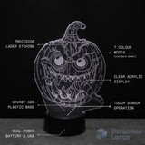 A 3D Halloween pumpkin lamp. Text callouts describing features; laser etching, colour modes, clear acrylic, sturdy base, touch sensor, and dual-power.