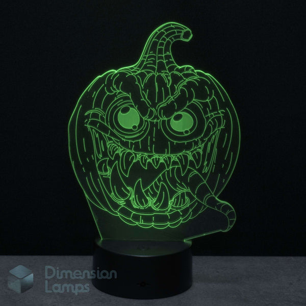 A glowing green 3D illusion lamp of a spooky jack-o'-lantern face on a black base against a dark background. Halloween themed decoration light.