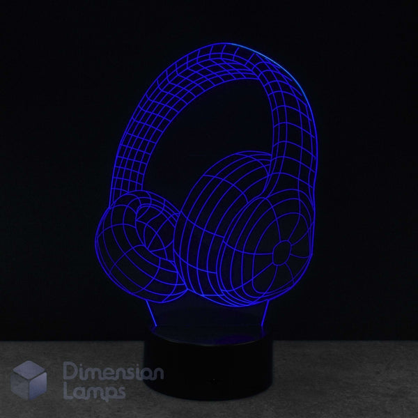 A 3D LED night lamp of over-ear headphones, glowing with a vibrant blue wireframe design on a black base against a dark background. Music gift. 