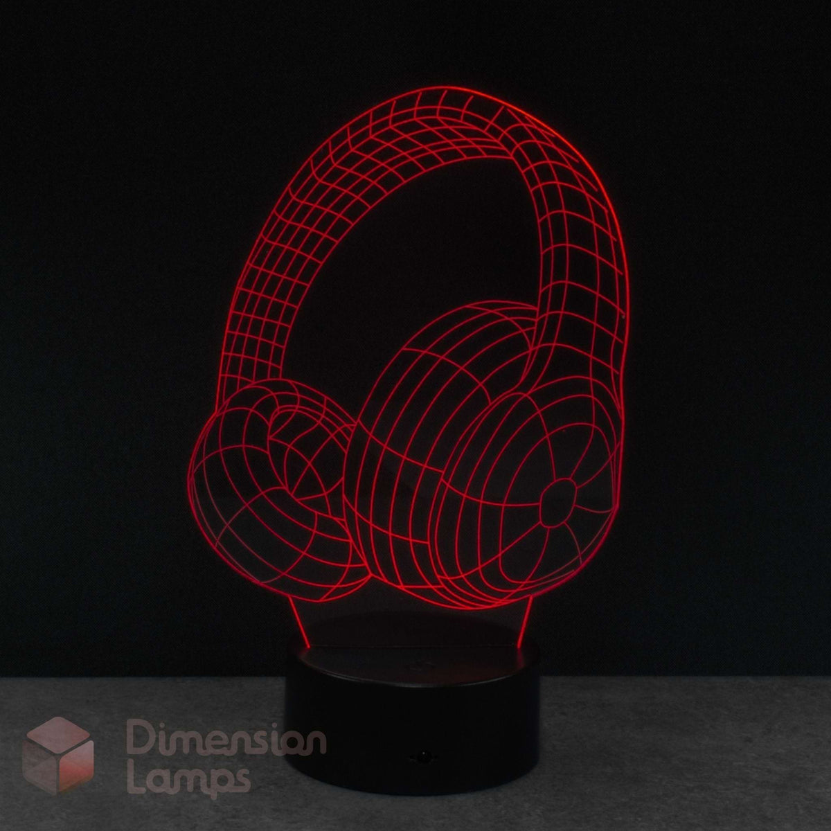An LED night lamp of over-ear headphones, glowing with red wireframe lines on a black base with a Dimension Lamps logo. Ideal music fan gift idea. 