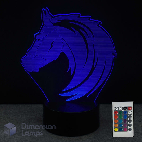 Blue horse-shaped lamp with remote control on a dark background
