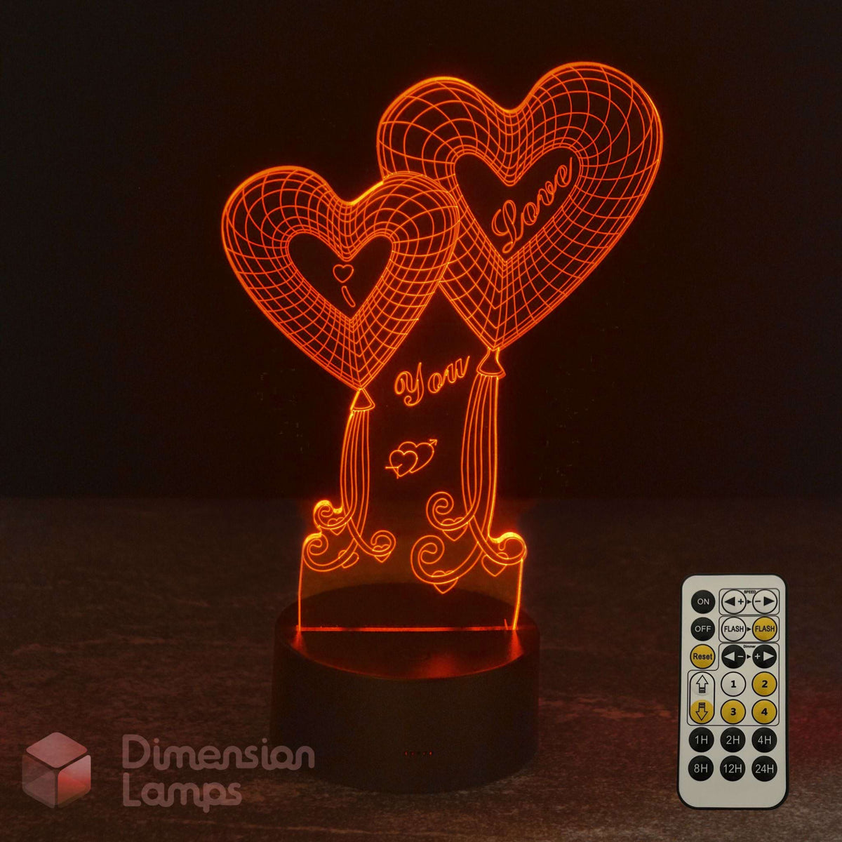 An illuminated 3D optical illusion night light shaped like two heart balloons with the words 'I Love You' on a dark base, shown with a remote control on a dark background. The brand name 'Dimension Lamps' appears in the lower-left corner.