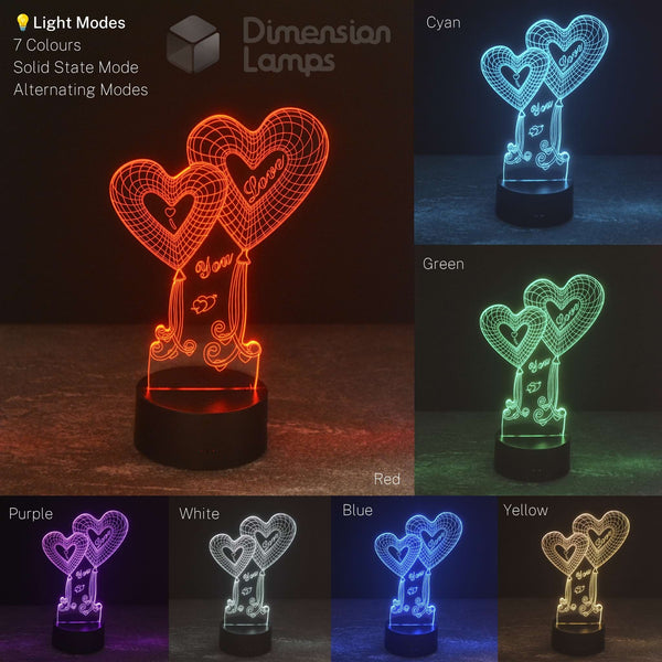 An LED dimension lamp showing multiple color modes in a 2x3 grid: red, cyan, green, purple, white, blue, and yellow. The main highlighted mode on the left shows two interlocking heart shapes with decorative script details on a black base, with text labels indicating light modes and colors.