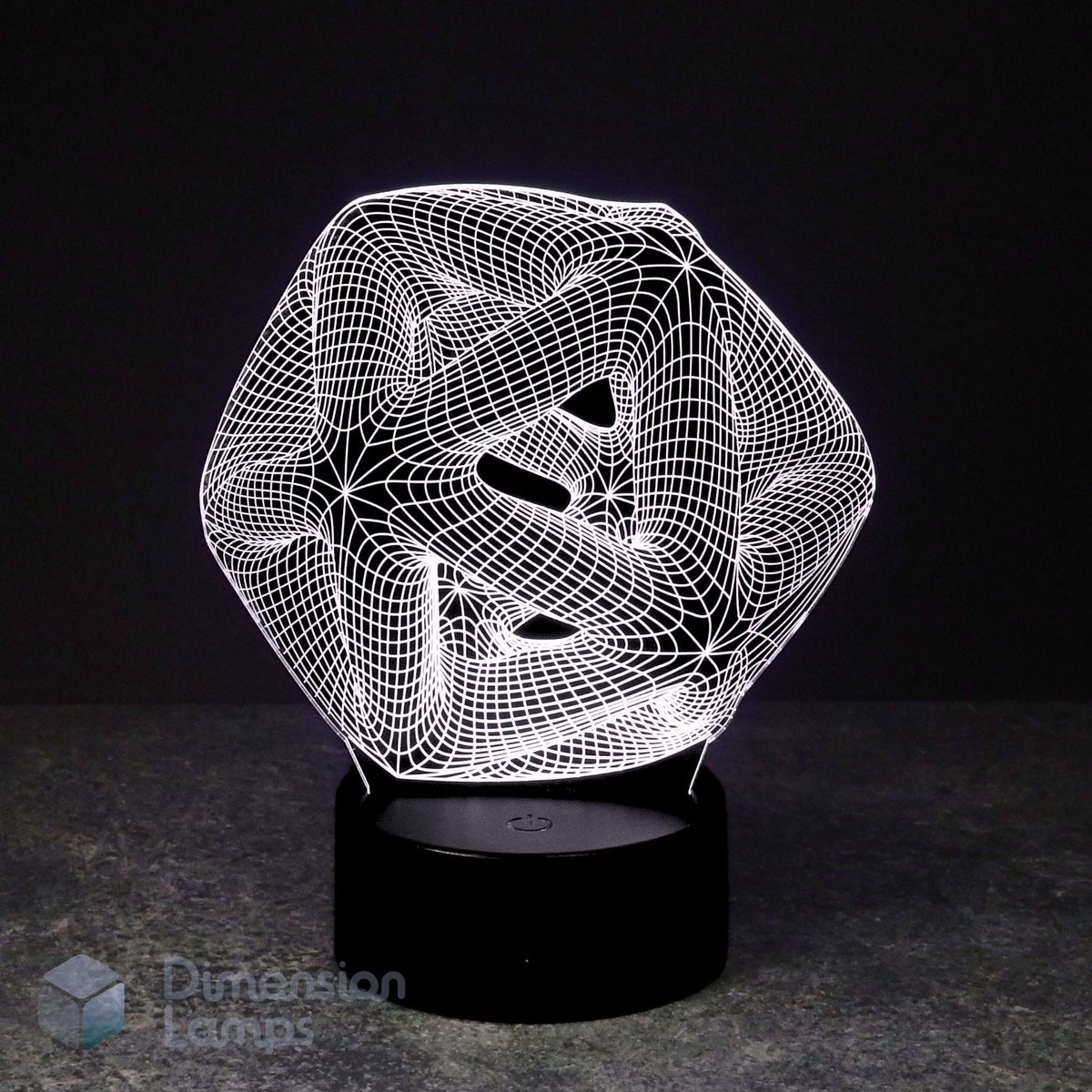 A 3D optical illusion lamp featuring a white wireframe icosahedron geometric design that creates a swirling, abstract effect, resting on a black cylindrical base against a dark background.