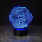 A 3D optical illusion LED lamp with a glowing blue geometric Icosahedron pattern on a black cylindrical base, set against a dark background.
