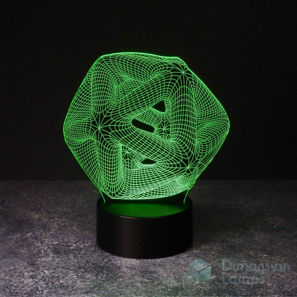 A 3D optical illusion LED lamp displaying a green wireframe icosahedron geometric design on a black base, set against a dark background.
