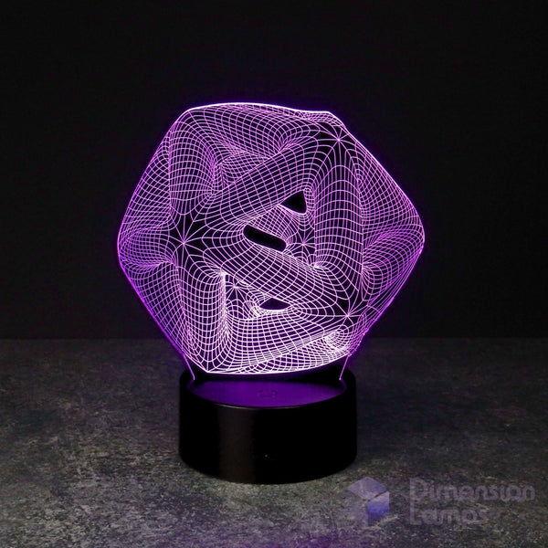 A 3D optical illusion LED lamp with a purple glowing geometric icosahedron design on a black cylindrical base, set against a dark background.