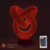A 3D optical illusion LED night light shaped like an interlocking knot, glowing with a warm red-orange light on a dark base. A small remote control is shown in the lower right corner, and the brand name 'Dimension Lamps' appears in the lower left.