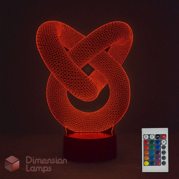 A 3D optical illusion LED night light shaped like an interlocking knot, glowing with a warm red-orange light on a dark base. A small remote control is shown in the lower right corner, and the brand name 'Dimension Lamps' appears in the lower left.