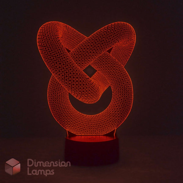A 3D optical illusion LED lamp featuring an interlocking knot design glowing in red-orange, set against a dark background with a brand watermark in the lower-left corner.