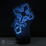 Blue LED lamp shaped like a Christian or Catholic cross with 'Jesus' text on a black background.