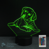 3D LED lamp shaped like a Labrador golden retriever puppy with a remote control on a dark background