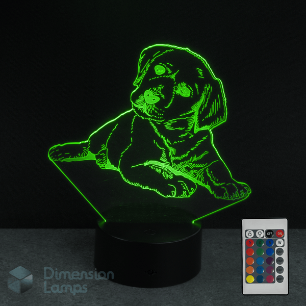 3D LED lamp shaped like a Labrador golden retriever puppy with a remote control on a dark background