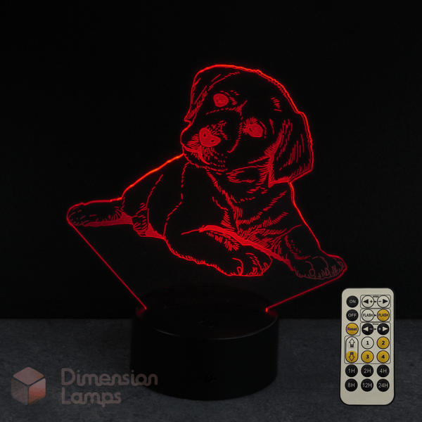 3D LED lamp with a Labrador golden retriever puppy design and remote control on a dark background