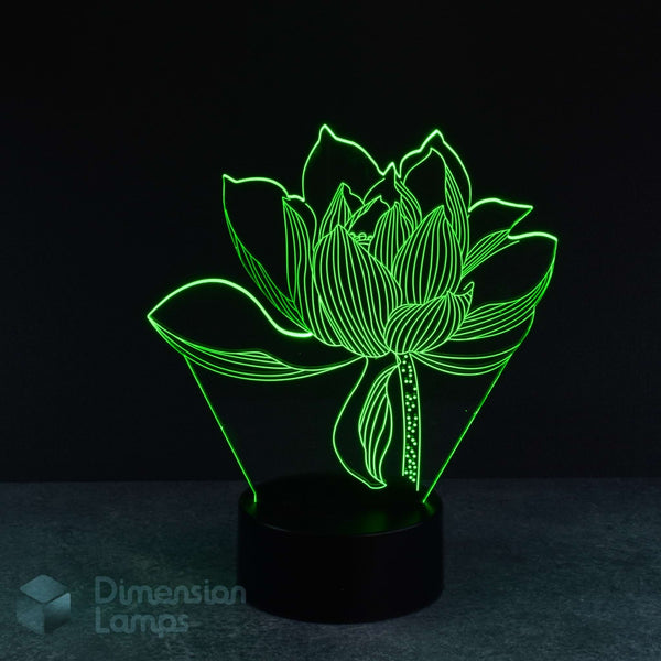 A 3D optical illusion LED night light shaped like a lotus flower, glowing with bright green lines on a black base against a dark background. The brand name 'Dimension Lamps' is visible as a watermark in the bottom-left corner.