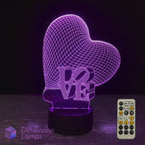 A heart-shaped 3D optical illusion night light glowing with purple LED lines, featuring the word 'LOVE' in a stylized cut-out design on a black base. Heart-shaped LED lamp with 'LOVE' text and remote control on a dark background. Girls gift idea. 